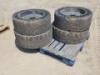 (4) RIMS W/SOLID TIRES, fits Bobcat Skidsteer. **(LOCATED IN COLTON, CA)**